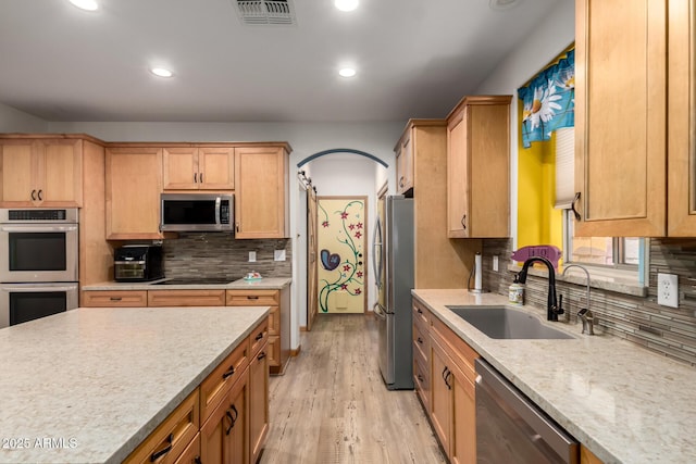 16210 W Durango St, Goodyear, AZ 85338 - kitchen with stainless steel appliances, recessed lighting, backsplash, light wood-style flooring, and light stone countertops