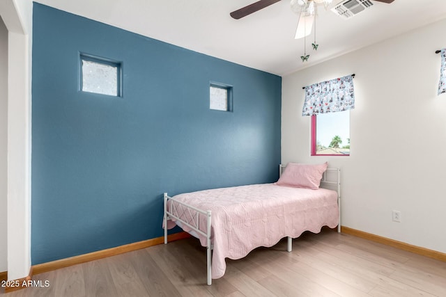 16210 W Durango St, Goodyear, AZ 85338 - bedroom featuring wood finished floors, multiple windows, and ceiling fan