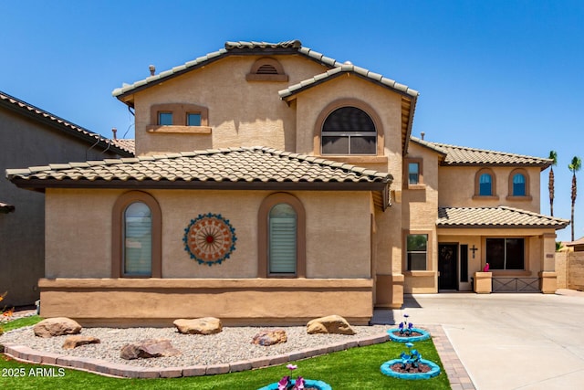 16210 W Durango St, Goodyear, AZ 85338 - mediterranean / spanish-style house featuring a tile roof, stucco siding, and concrete driveway