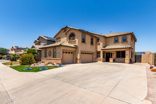 16210 W Durango St, Goodyear, AZ 85338 - mediterranean / spanish house with a garage, a tiled roof, stucco siding, and driveway