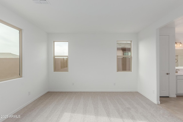 spare room with light carpet