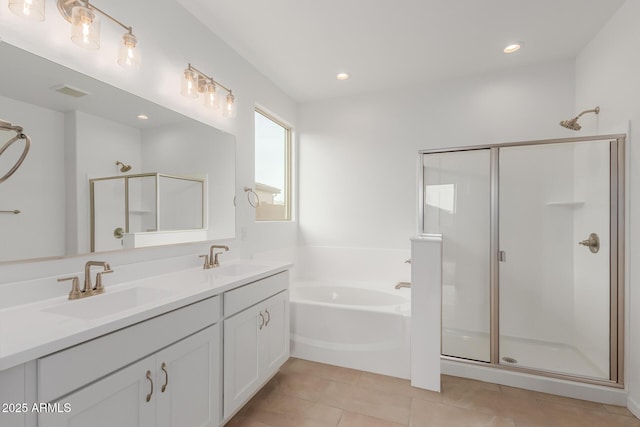 bathroom with plus walk in shower, vanity, and tile patterned floors