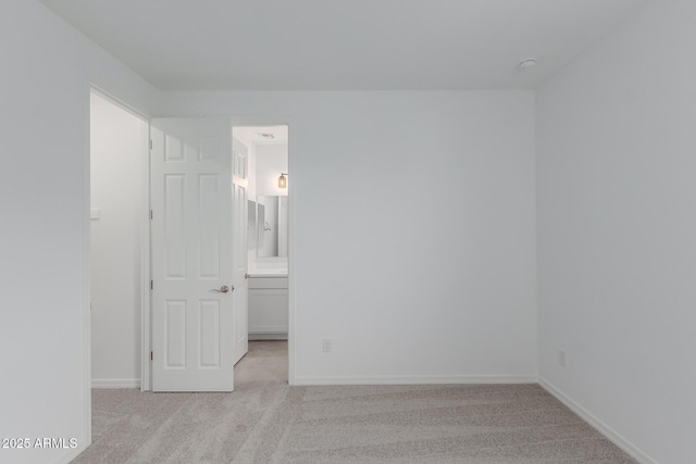 spare room with light colored carpet