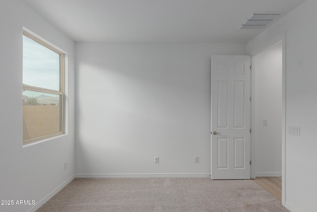 spare room with light colored carpet