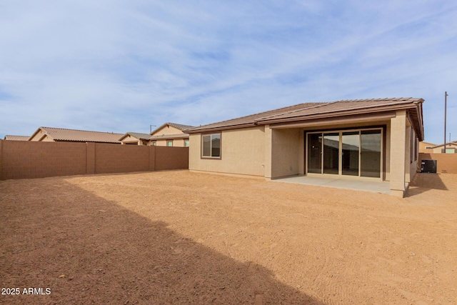 rear view of property with central AC unit