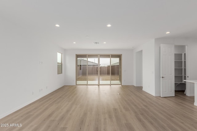 unfurnished room with light wood-type flooring