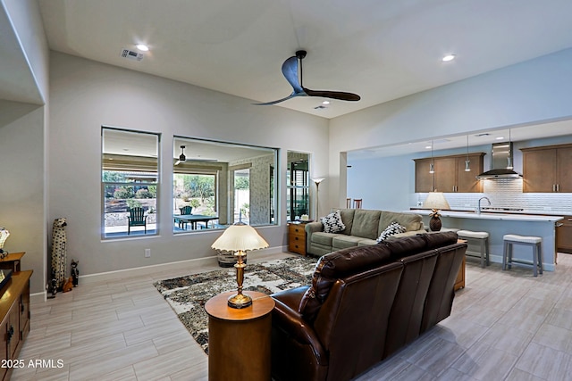 living room featuring sink and ceiling fan