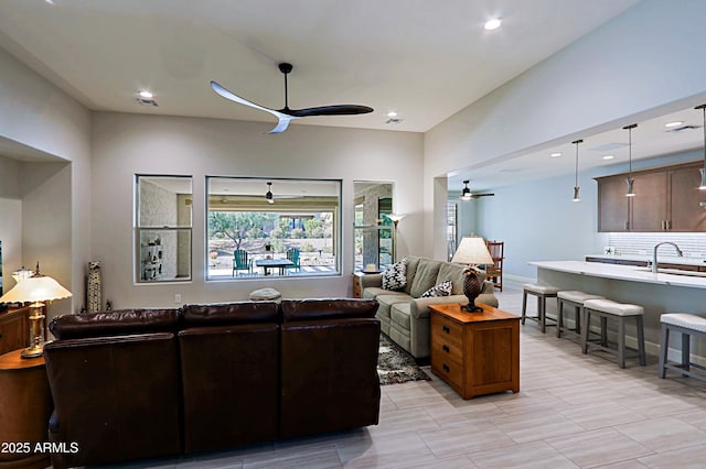 living room featuring sink and ceiling fan