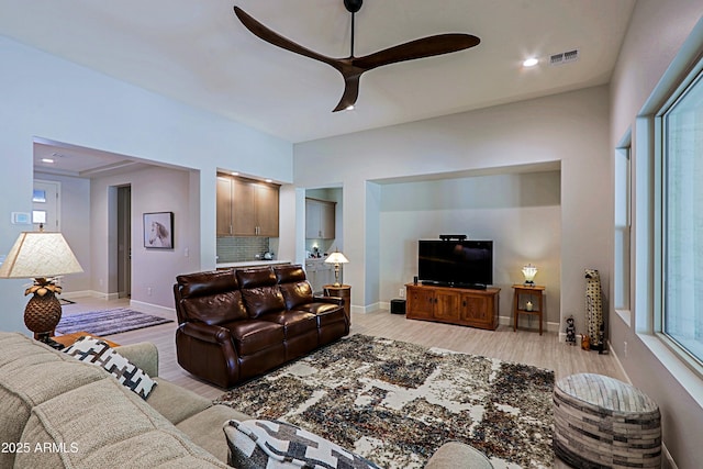 living room with light hardwood / wood-style floors and ceiling fan