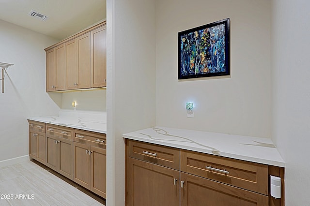 kitchen featuring light stone counters