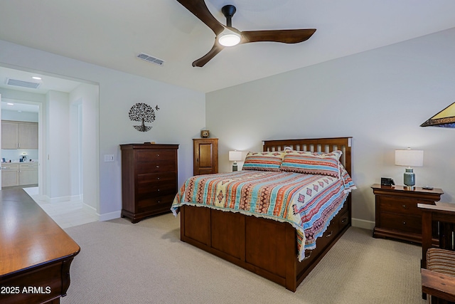 carpeted bedroom with connected bathroom and ceiling fan