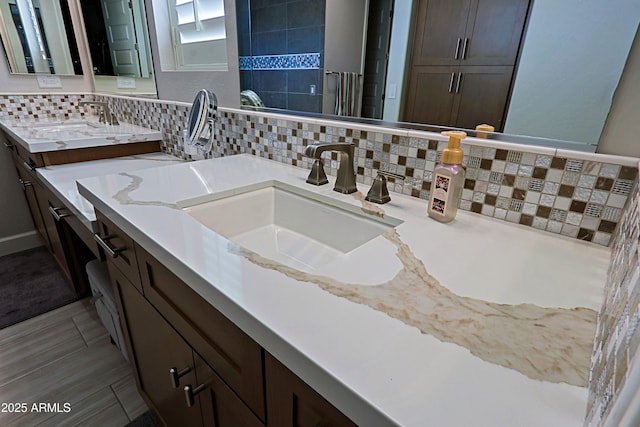 bathroom featuring vanity and backsplash