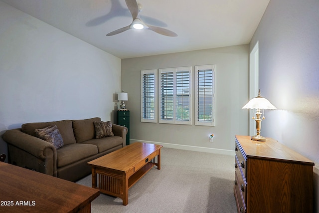 carpeted living room with ceiling fan