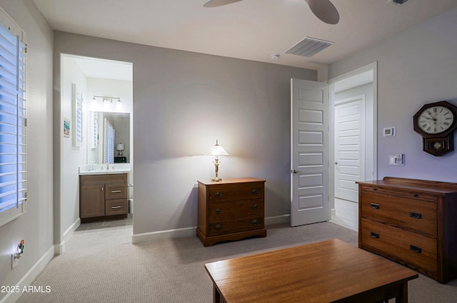 carpeted bedroom with ceiling fan and connected bathroom