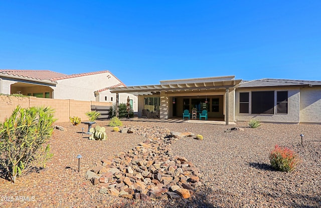 rear view of house featuring a pergola and a patio area