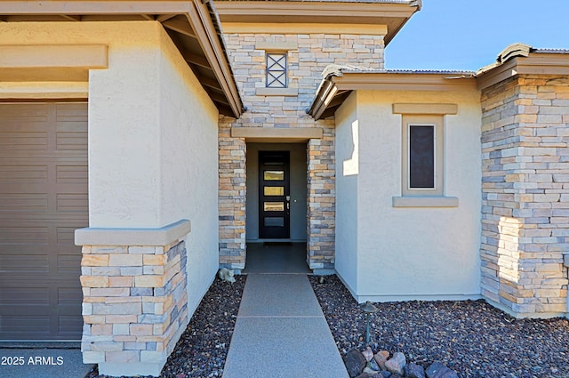 view of exterior entry with a garage