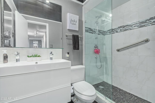 full bathroom featuring toilet, a walk in shower, backsplash, and vanity