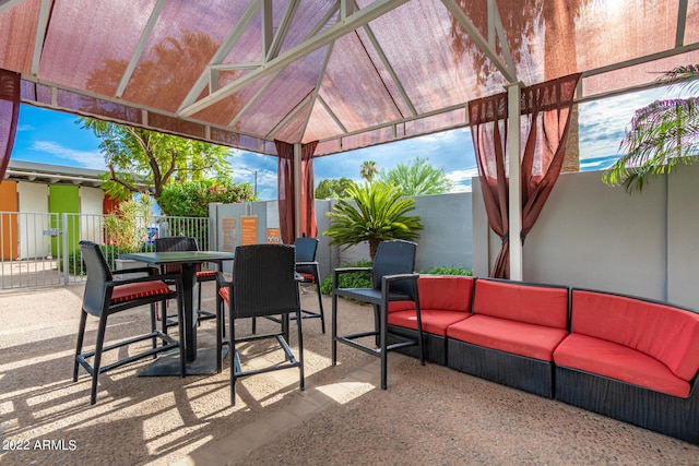 view of patio / terrace with an outdoor hangout area, a gazebo, outdoor dining space, and fence