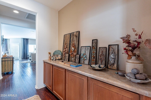 hallway with dark hardwood / wood-style flooring