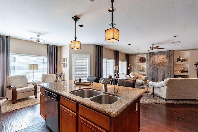 kitchen featuring a kitchen island with sink, decorative light fixtures, sink, stainless steel dishwasher, and ceiling fan