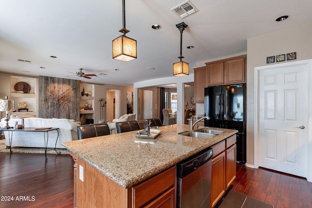 kitchen featuring sink, pendant lighting, an island with sink, and stainless steel dishwasher