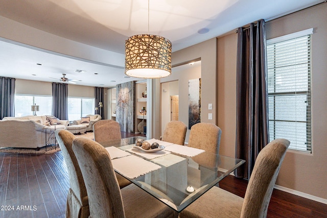 dining space with ceiling fan and dark hardwood / wood-style floors