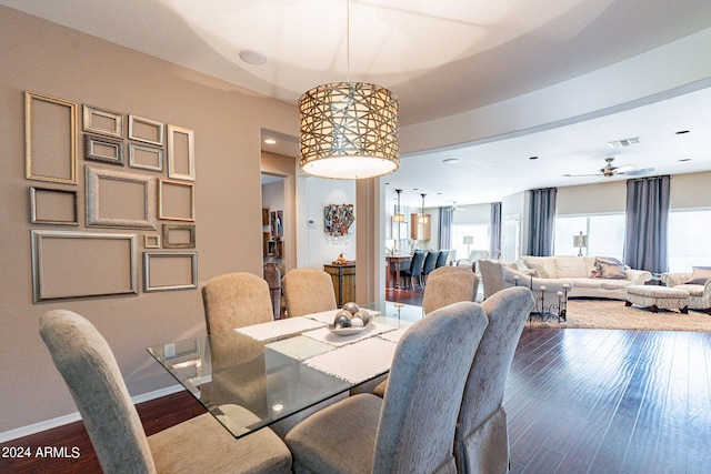 dining space with dark wood-type flooring and ceiling fan