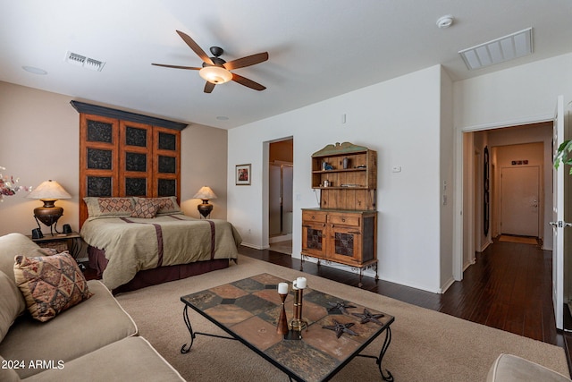 bedroom with dark hardwood / wood-style floors and ceiling fan