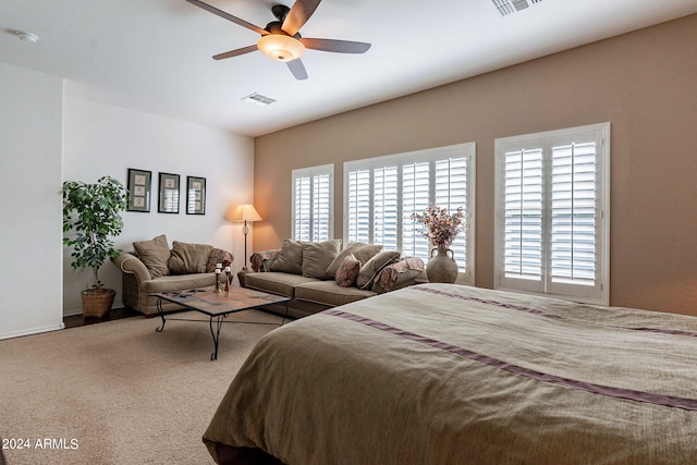 bedroom with carpet floors, ceiling fan, and multiple windows