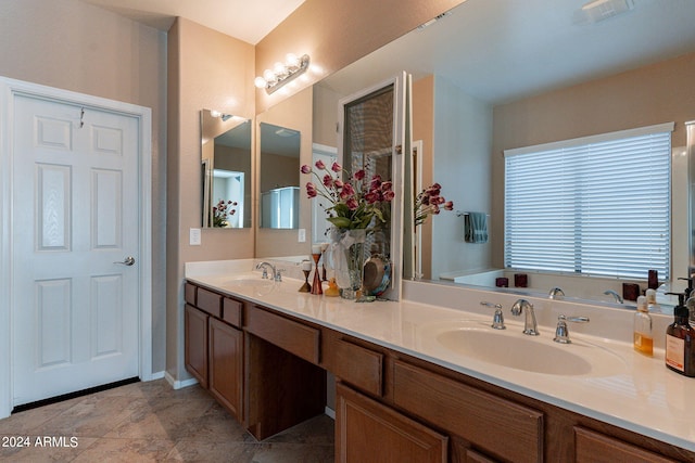 bathroom with tile flooring, a bath to relax in, and dual bowl vanity