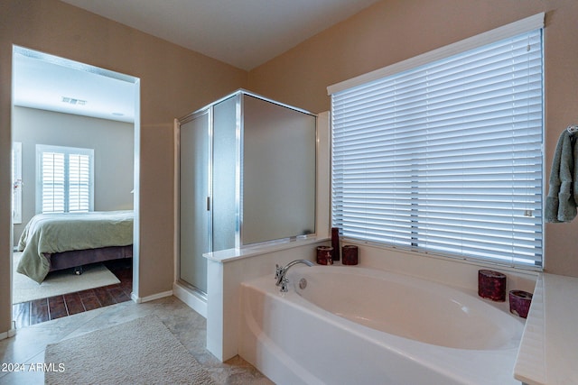 bathroom with shower with separate bathtub