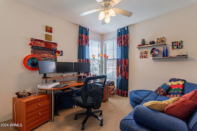 carpeted office space with ceiling fan