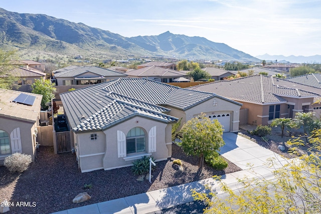 exterior space with a mountain view and a garage