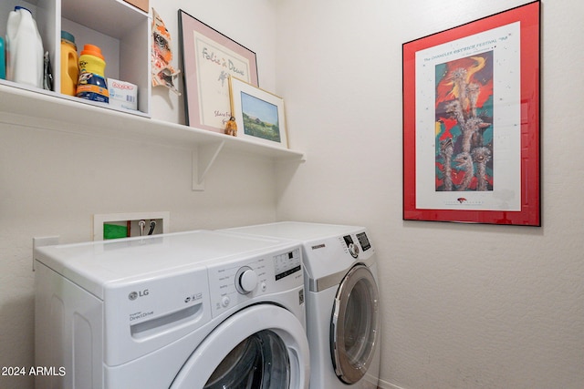 clothes washing area featuring washer hookup and washer and clothes dryer