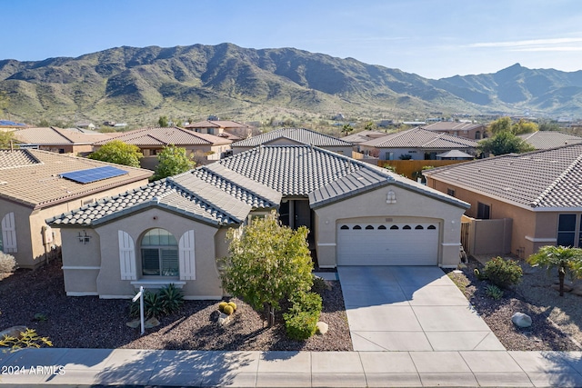 view of front facade with a mountain view and a garage