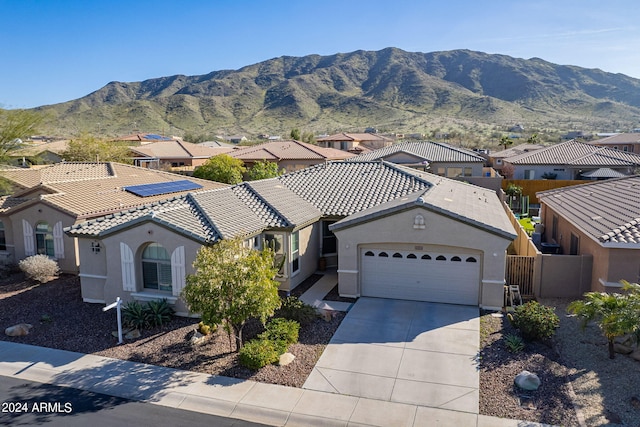 view of front facade with a mountain view and a garage