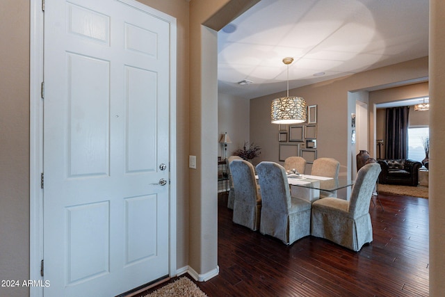 dining space with dark hardwood / wood-style flooring