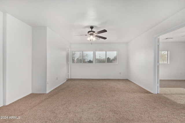 spare room featuring visible vents, baseboards, ceiling fan, and carpet floors