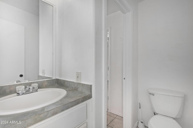 bathroom with tile patterned flooring, toilet, and vanity