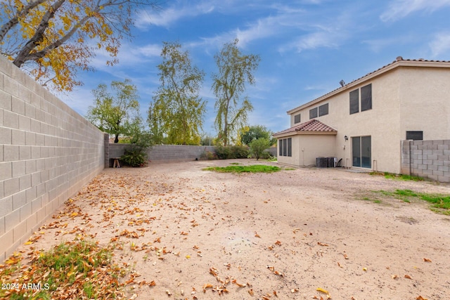 view of yard featuring central AC unit and a fenced backyard