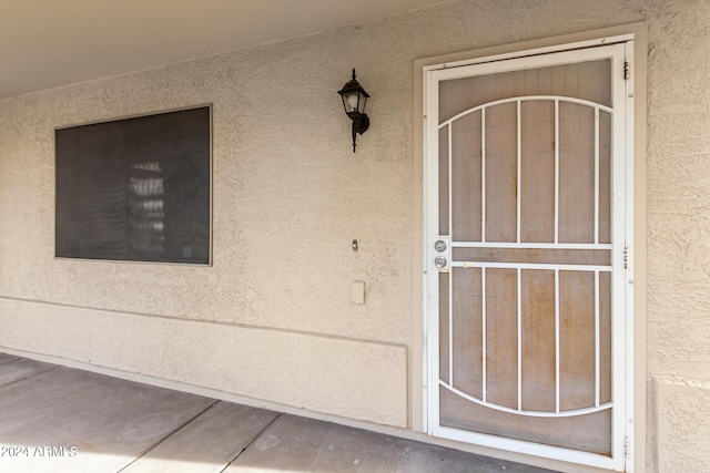 entrance to property with stucco siding