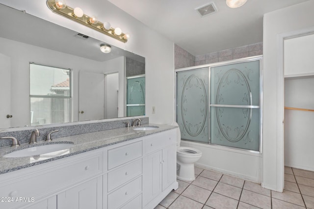 full bathroom with tile patterned floors, visible vents, and a sink