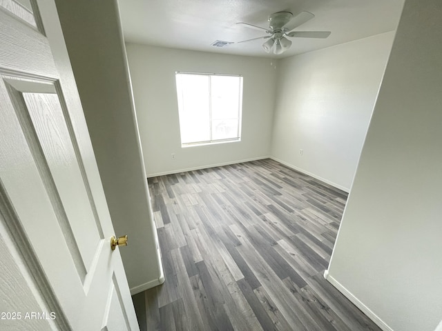 spare room with hardwood / wood-style floors and ceiling fan