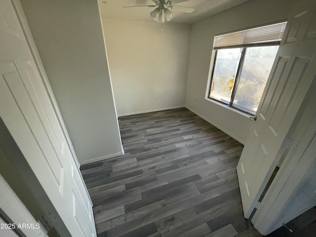 unfurnished room featuring dark wood-type flooring and ceiling fan