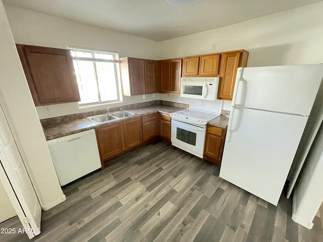 kitchen featuring dark hardwood / wood-style flooring, sink, and white appliances