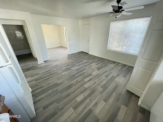 interior space with dark wood-type flooring and ceiling fan