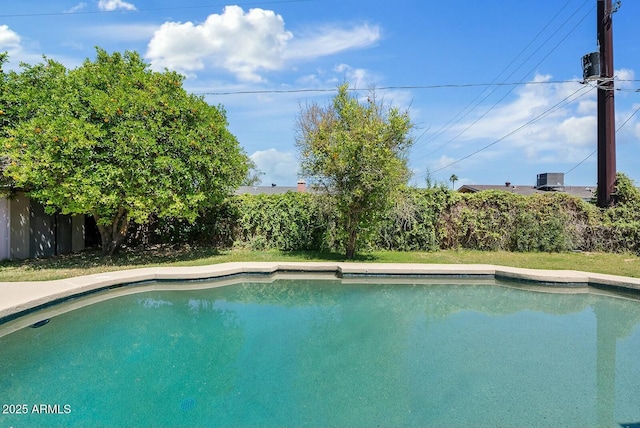 outdoor pool with a fenced backyard
