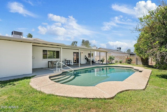 view of pool with a lawn, fence, a fenced in pool, and a patio area