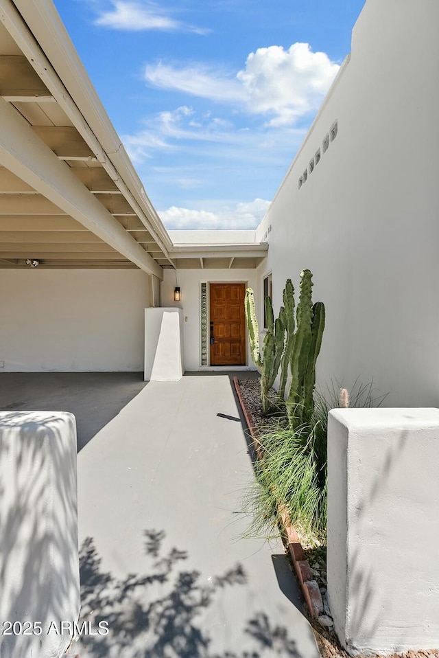 entrance to property with stucco siding