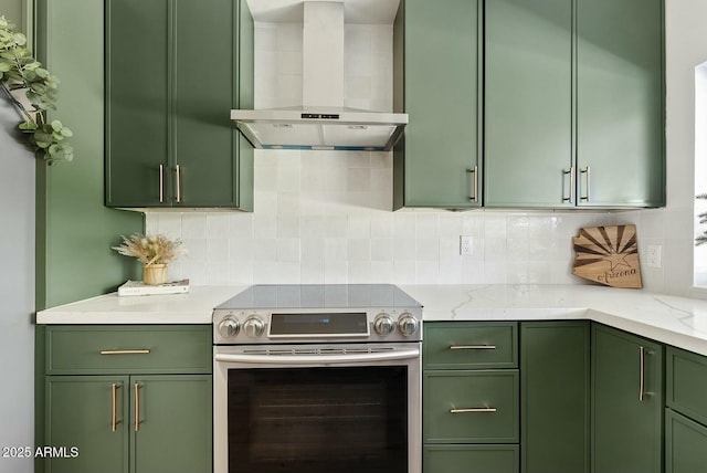 kitchen featuring green cabinetry, stainless steel range with electric stovetop, backsplash, and wall chimney range hood